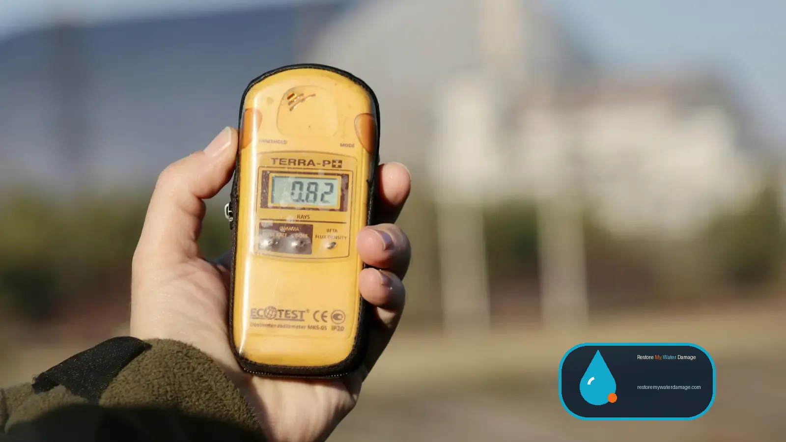 Hand holding a yellow digital meter like those used in water damage restoration Huntersville North Charlotte, NC