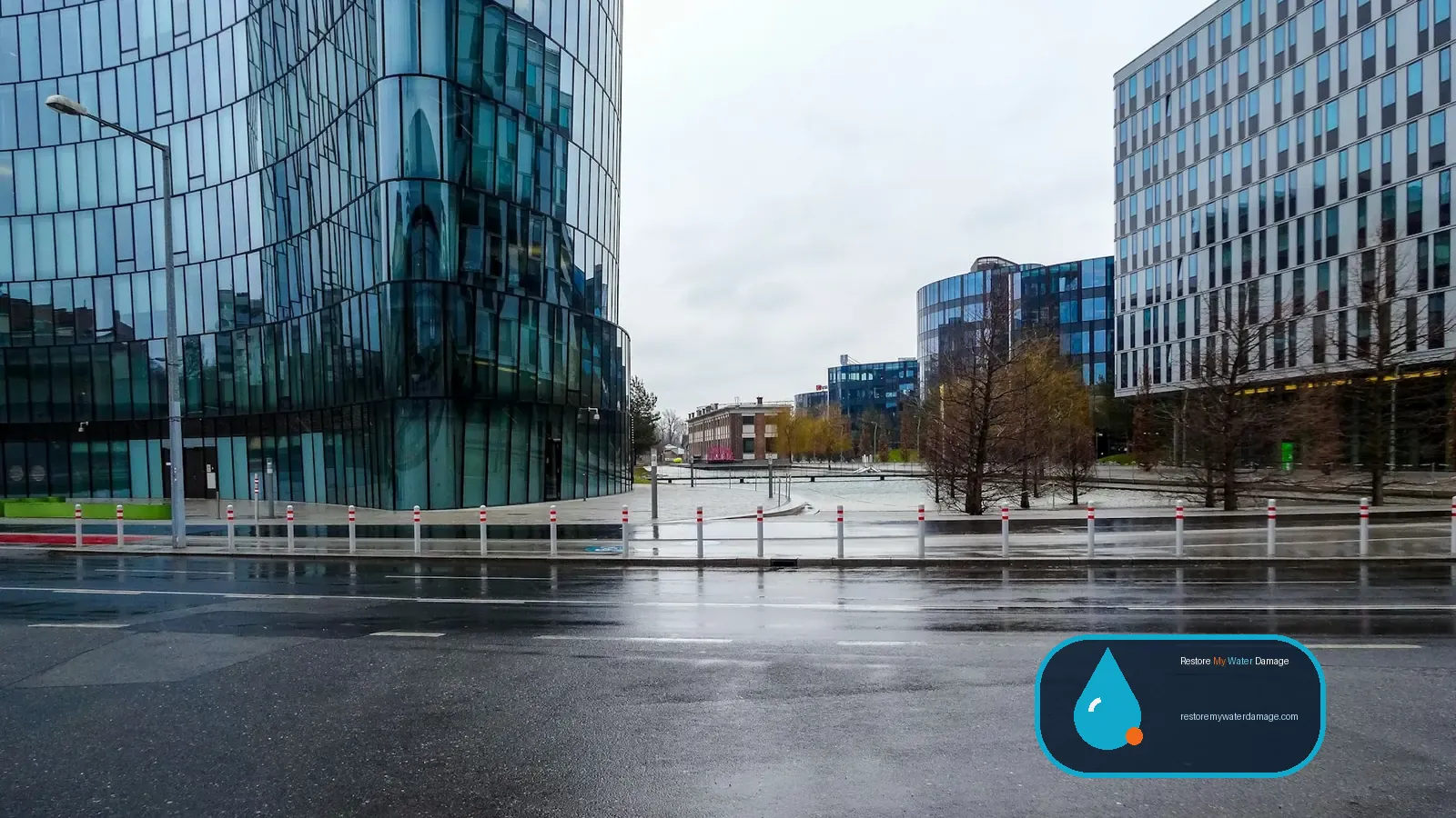 Glass office buildings beside a rain-soaked street, a setting for water damage restoration Plano Richardson, TX